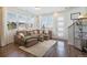 Living area with sectional sofa, wood floors, and lots of natural light at 7880 Horsebrush Ln # A, Littleton, CO 80125