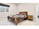 Cozy bedroom featuring a wooden bed frame and a functional window at 23270 E Rockinghorse Pkwy, Aurora, CO 80016