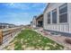 Charming backyard featuring lush grass and a modern home exterior with stylish architectural details at 4797 Saddle Iron Rd, Castle Rock, CO 80104