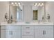 Elegant bathroom featuring dual sinks, white cabinetry, quartz countertops, and modern fixtures at 4797 Saddle Iron Rd, Castle Rock, CO 80104