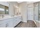 Bathroom with double sink vanity, large mirror, and glass enclosed shower at 4797 Saddle Iron Rd, Castle Rock, CO 80104