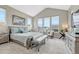 Bedroom with large windows, seating area, and vaulted ceilings at 4797 Saddle Iron Rd, Castle Rock, CO 80104