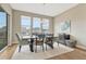 Bright dining room with large windows and stylish decor with table set for six at 4797 Saddle Iron Rd, Castle Rock, CO 80104