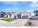 A beautifully designed single-story home with a two-car garage and a well-manicured lawn at 4797 Saddle Iron Rd, Castle Rock, CO 80104