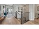 Open hallway featuring hardwood floors, wrought iron banister, and views into the front entryway at 4797 Saddle Iron Rd, Castle Rock, CO 80104