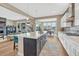 Open kitchen and living area with a center island and natural light throughout the home at 4797 Saddle Iron Rd, Castle Rock, CO 80104