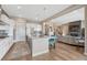 Bright kitchen featuring a large center island with seating and stainless steel appliances, connected to living area at 4797 Saddle Iron Rd, Castle Rock, CO 80104