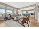 Open-concept living room and kitchen area featuring a breakfast bar and floor to ceiling windows at 4797 Saddle Iron Rd, Castle Rock, CO 80104