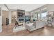 Large and airy living room with ample seating, hardwood floors, and modern fireplace feature at 4797 Saddle Iron Rd, Castle Rock, CO 80104