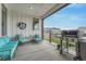 Cozy covered patio with comfortable seating and a built-in grill, perfect for outdoor entertaining at 4797 Saddle Iron Rd, Castle Rock, CO 80104