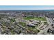 Overhead view captures the layout of a community, highlighting a school building with a large playing field and parking area at 590 S Troy St, Aurora, CO 80012