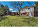 Expansive backyard with lush green lawn, mature trees, and a charming pergola at 590 S Troy St, Aurora, CO 80012