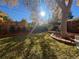 Inviting backyard with green grass, stone-lined garden, and a charming shaded pergola at 590 S Troy St, Aurora, CO 80012
