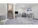 Cozy basement with staircase, rug, chair, and tv at 590 S Troy St, Aurora, CO 80012