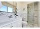 Bright bathroom featuring a glass shower with decorative tile and white marble vanity at 590 S Troy St, Aurora, CO 80012