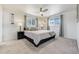 Bright main bedroom with neutral carpet, ceiling fan, and two windows at 590 S Troy St, Aurora, CO 80012