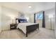 Comfortable bedroom featuring a full bed, carpet flooring, and bright window at 590 S Troy St, Aurora, CO 80012