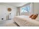 Bright bedroom featuring a full bed, carpet flooring, and bright window at 590 S Troy St, Aurora, CO 80012