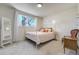 Bright bedroom featuring a full bed, carpet flooring, and bright window at 590 S Troy St, Aurora, CO 80012