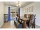 Dining area with a wooden table and upholstered bench seating and sliding glass doors at 590 S Troy St, Aurora, CO 80012