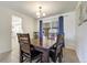Dining space with a wood table, tile floors, and a view into the adjacent living room at 590 S Troy St, Aurora, CO 80012