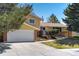 Charming two story house with a brick and siding exterior and a manicured front yard at 590 S Troy St, Aurora, CO 80012
