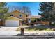 Inviting two-story home with a well-maintained lawn and attached two car garage at 590 S Troy St, Aurora, CO 80012