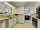 Efficient kitchen layout featuring tile backsplash, updated appliances, and ample counter space at 590 S Troy St, Aurora, CO 80012