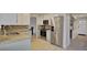 Well lit kitchen with tile floors, stainless steel refrigerator and stone countertops at 590 S Troy St, Aurora, CO 80012