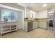 Bright eat-in kitchen featuring tile floors, stainless steel dishwasher, and ample natural light at 590 S Troy St, Aurora, CO 80012