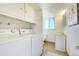 Clean, organized laundry room with washer, dryer, sink and ample storage at 590 S Troy St, Aurora, CO 80012