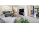 Comfortable living room showing neutral carpet, large TV, staircase, and sectional sofa at 590 S Troy St, Aurora, CO 80012