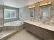 Beautiful bathroom with a large soaking tub, dual sinks, marble countertops, and modern tile at 20567 E Weaver Dr, Aurora, CO 80016