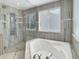 Luxurious bathroom showcasing a walk-in shower, large soaking tub, and modern fixtures at 20567 E Weaver Dr, Aurora, CO 80016