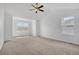 Bright, spacious bedroom with neutral carpeting, vaulted ceiling, and natural light from two windows at 20567 E Weaver Dr, Aurora, CO 80016