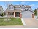 Charming two-story home featuring a brick facade, a covered porch and an attached garage at 20567 E Weaver Dr, Aurora, CO 80016