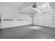 Clean two car garage with white walls and grey epoxy floor at 20567 E Weaver Dr, Aurora, CO 80016