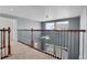 Upstairs hallway boasts views and a decorative railing for a luxurious touch to the home's design at 20567 E Weaver Dr, Aurora, CO 80016