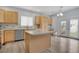 The kitchen has an island, stainless steel appliances, and patio access for easy indoor-outdoor living at 20567 E Weaver Dr, Aurora, CO 80016