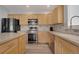 A well-equipped kitchen boasts an island, stainless steel appliances, and ample counter space for cooking at 20567 E Weaver Dr, Aurora, CO 80016