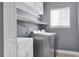 Convenient laundry room includes shelving, storage, modern appliances, and natural light for easy chores at 20567 E Weaver Dr, Aurora, CO 80016