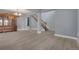 Spacious living area with modern flooring, gray walls, and a staircase with dark wood handrail and white spindles at 20567 E Weaver Dr, Aurora, CO 80016