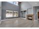 Bright living room boasting a high ceiling, large windows, a fireplace, and open built in shelving at 20567 E Weaver Dr, Aurora, CO 80016