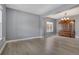 Open-concept living room featuring modern gray walls, light-colored floors, and a classic wooden cabinet at 20567 E Weaver Dr, Aurora, CO 80016
