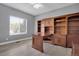 This home office features custom wood built-ins, a desk, and natural light for a productive workspace at 20567 E Weaver Dr, Aurora, CO 80016