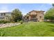 Backyard showcasing a well-maintained lawn, deck, and landscaping at 24702 E Ontario Dr, Aurora, CO 80016