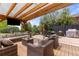 Enjoy the expansive backyard patio featuring an outdoor dining area, grill, and cozy seating around a fire pit at 24702 E Ontario Dr, Aurora, CO 80016