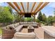 Relax on the spacious backyard patio with comfortable seating under a pergola, ideal for outdoor living and entertaining at 24702 E Ontario Dr, Aurora, CO 80016