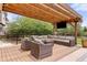 Inviting backyard patio with a covered pergola, comfortable seating, and outdoor TV perfect for relaxation and entertaining at 24702 E Ontario Dr, Aurora, CO 80016
