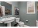 Small half bathroom with unique fixtures and grey walls that are decorated with art at 24702 E Ontario Dr, Aurora, CO 80016